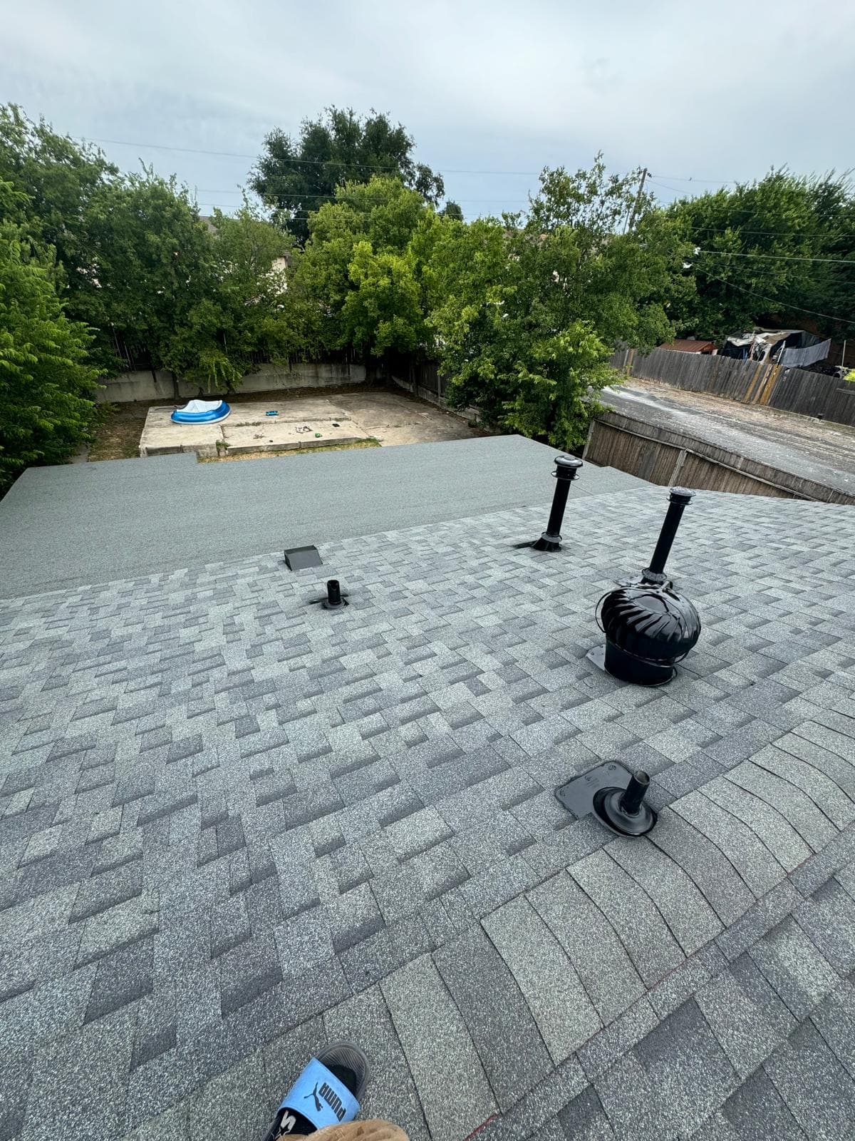 Completed Central Texas roof with attic ventilation and roof vents installed along the ridge